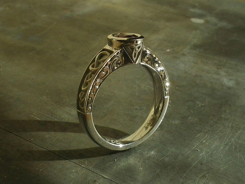 celtic inspired engagement ring with knots and triquetra symbol