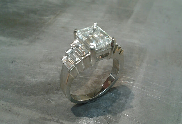Square diamonds in large banded white gold engagement ring