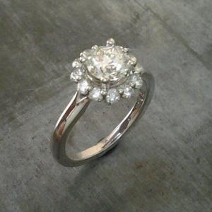 classic vintage style white gold engagement ring with round cut diamond in a halo setting top view