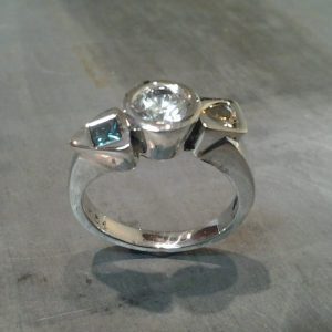 unique custom white gold engagement ring with custom set diamond and sapphire