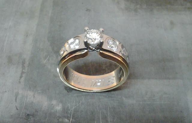 rose and white gold engagement ring with custom engraving and flush set diamond band top view