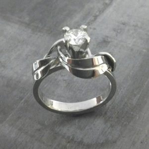 custom designed swirled leaves white gold band with princess cut diamond in cathedral setting