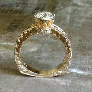 gold leaf filigree engagement ring with round diamond in bezel setting