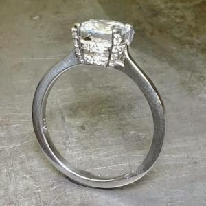 14k white gold slim band engagement ring with large princess cut diamond in a custom engraved channel setting