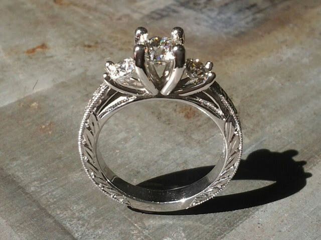 custom filigree white gold band with leaf accents and a triple cathedral set of diamonds