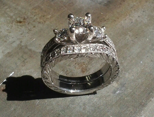 custom filigree white gold band with leaf accents and a triple cathedral set of diamonds with matching diamond band