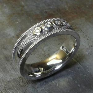 custom wedding band with three round diamonds and engraving