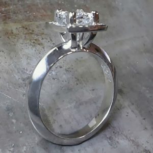 band with princess cut diamond in square halo setting side view