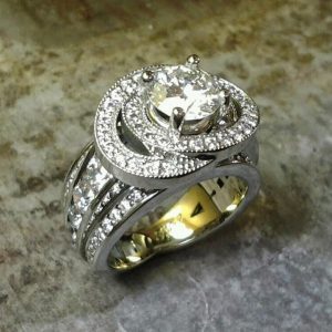 custom designed sphere ring with many diamonds in band and large round center diamond in halo setting