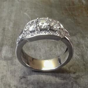 custom designed white gold engagement ring with three large diamonds surrounded by smaller ones side view