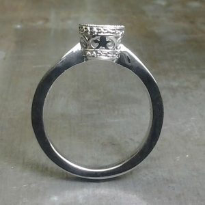 simple band with intricate round diamond setting