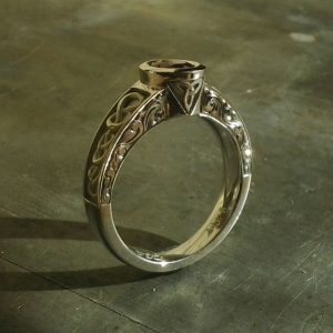 celtic inspired engagement ring with knots and triquetra symbol