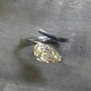 pale yellow teardrop diamond and unique open-style band