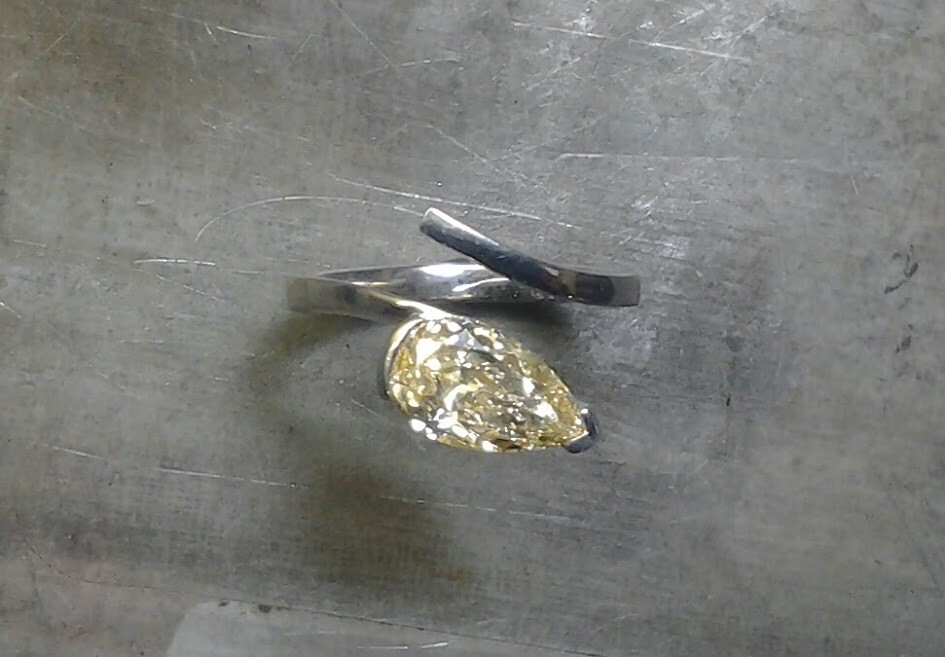 pale yellow teardrop diamond and unique open-style band