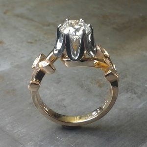 white gold and rose gold custom designed leaf band and princess cut diamond in cathedral setting