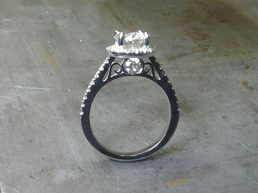 delicate white gold engagement ring with custom engraved band and large round center diamond side view