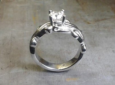 custom designed swirled band with princess cut center diamond side view