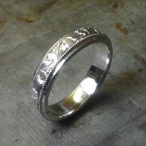 intricate custom engraved wedding band in white gold