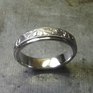 intricate custom engraved wedding band in white gold