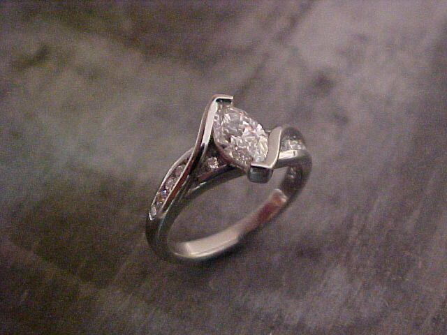 custom designed engagement ring with marquise diamond in tension setting