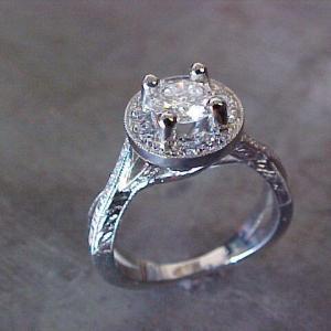 delicate engagement ring with custom designed band and round center diamond in halo setting