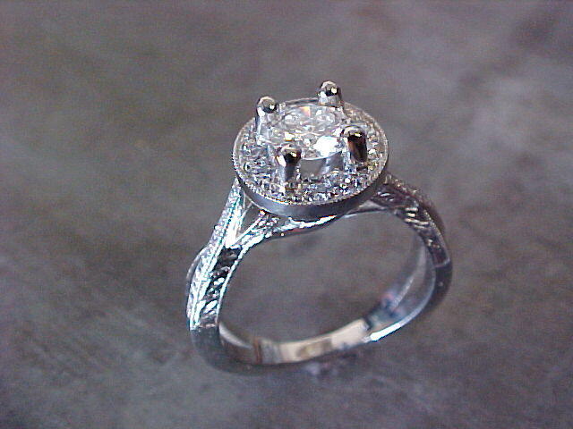 delicate engagement ring with custom designed band and round center diamond in halo setting
