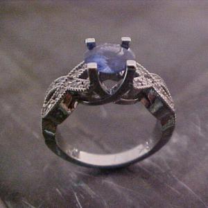 white gold ring with woven band and sapphire