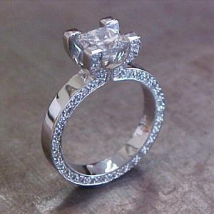 custom designed diamond band engagement ring with princess cut diamond in channel setting