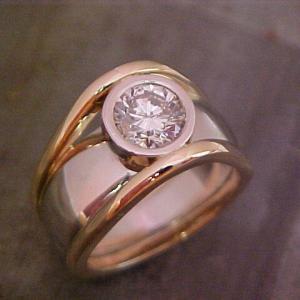 custom gold ring with round diamond in bezel setting