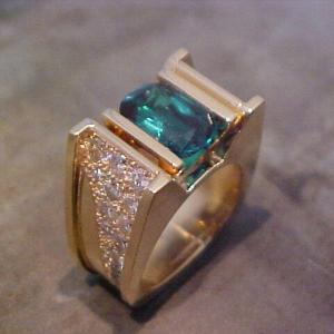 custom ring with gold and diamond band and large center emerald