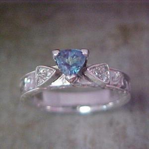 dainty white gold ring with custom engraving and light blue stone