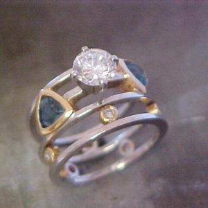 custom ring with triangle sapphires and large round center diamond