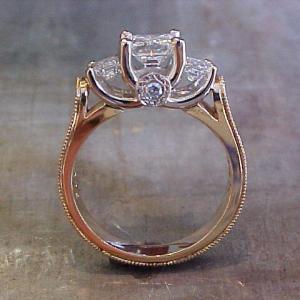 Lotus on side of 3 stone engagement ring