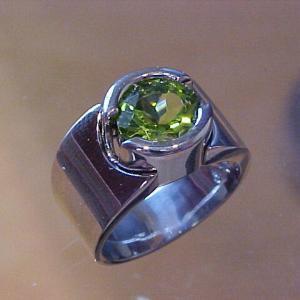 large platinum ring with round emerald in center