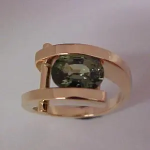 custom gold ring with tension set emerald