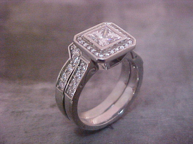 14k white gold custom engagement ring with matching wedding band and many diamonds