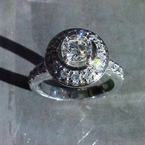 custom engagement ring with large round diamond in halo setting and diamond encrusted band