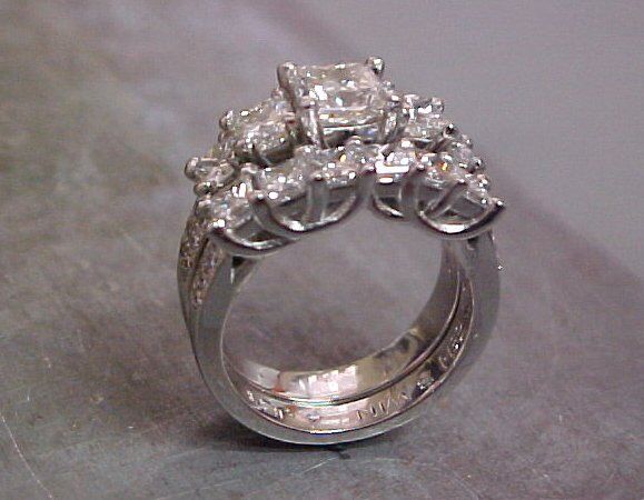 white gold custom engagement ring with diamond cluster and matching wedding band