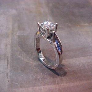 custom white gold solitaire engagement ring with side accent sapphires