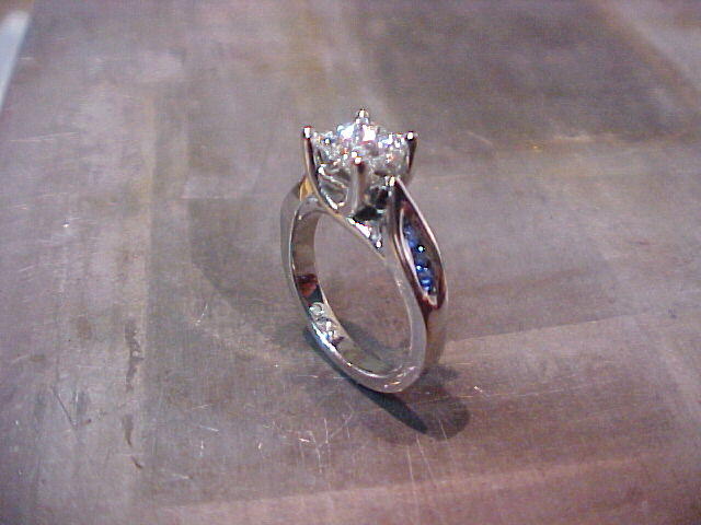 custom white gold solitaire engagement ring with side accent sapphires