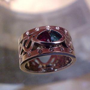 custom white gold ring with celtic engraving and ruby and emerald center gems top view
