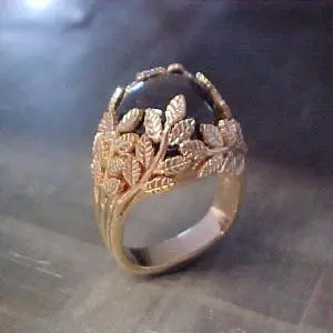 custom ring with leaf engraving holding center stone