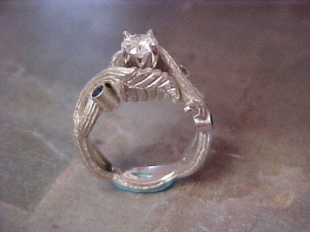 custom engagement ring with vine engraved band and saphire accents side view
