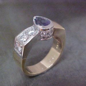 custom white gold ring with sapphire center stone and diamond band