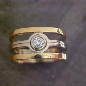 custom wedding ring with yellow and white gold and solitary round diamond top view