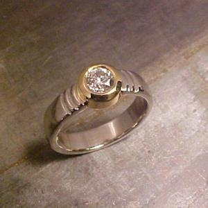 Custom white gold ring with round diamond in bezel setting