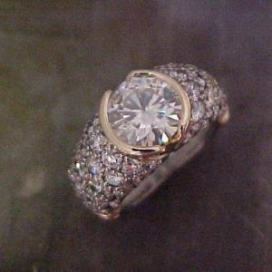 custom ring with diamond encrusted band and large round center diamond