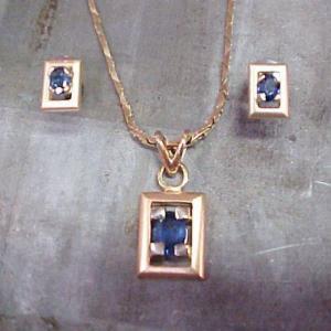 custom jewellery with pendant and matching earrings with sapphire accents