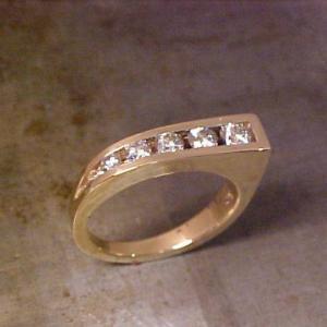 custom wedding ring in yellow gold with diamonds in a unique shape