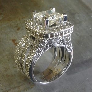 diamond encrusted engagement ring with large center stone side view